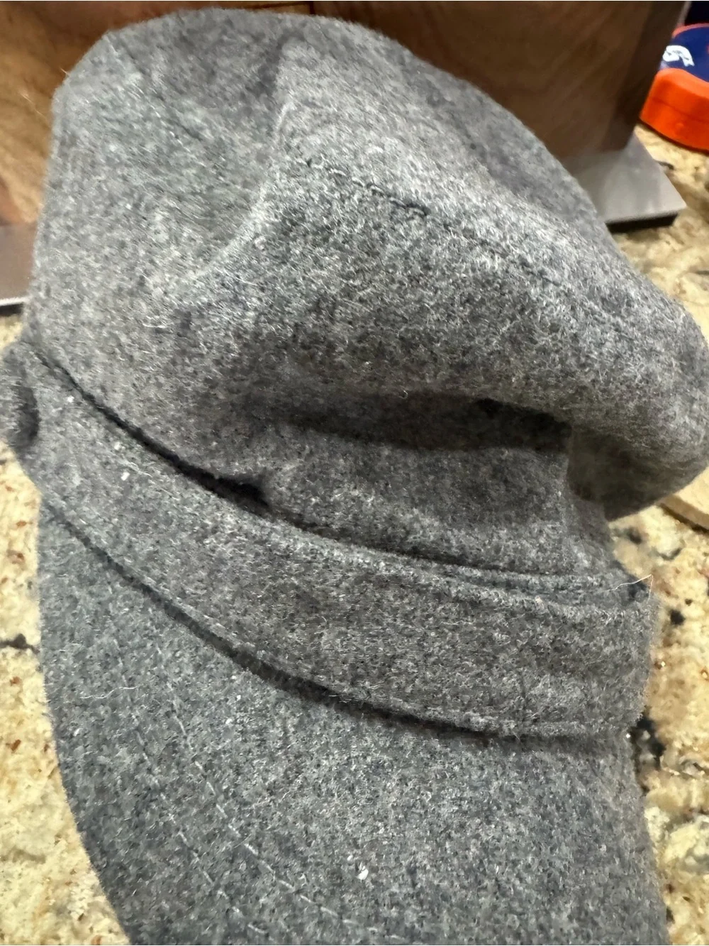 Gray newsboy cap features a felted wool blend material (CL-3)